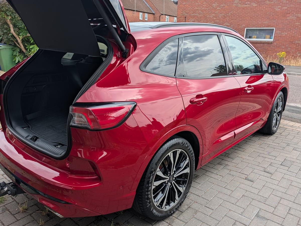 Clean red SUV with the boot open after a full valet